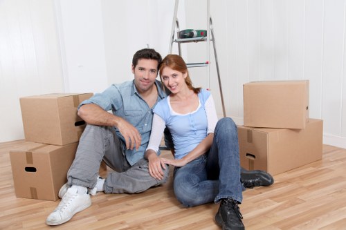 Professional movers loading household items for an apartment relocation