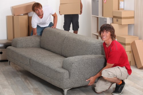Local movers handling packed boxes in a busy Elephant and Castle property